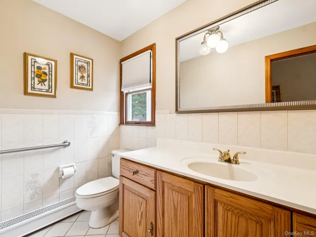 a bathroom with a sink a toilet and mirror