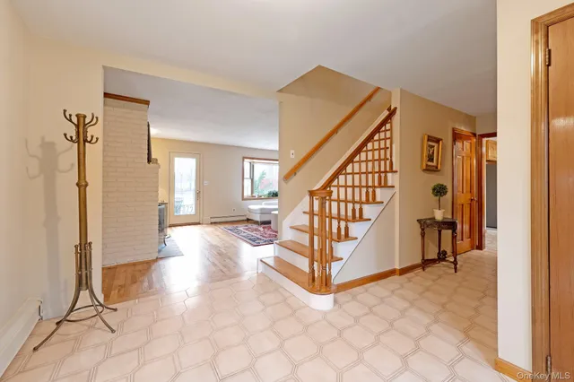 a view of entryway with wooden floor and livingroom view