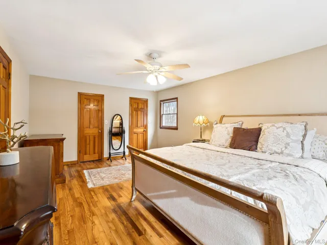 a spacious bedroom with a bed and a chandelier