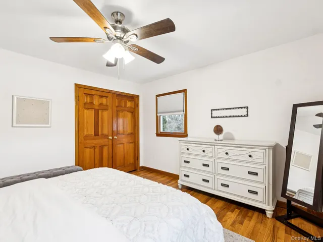a bedroom with a bed and a flat tv screen