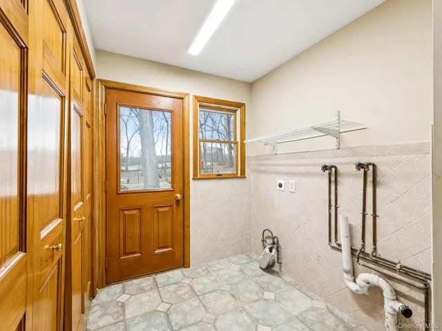 a bedroom with a bed and large windows