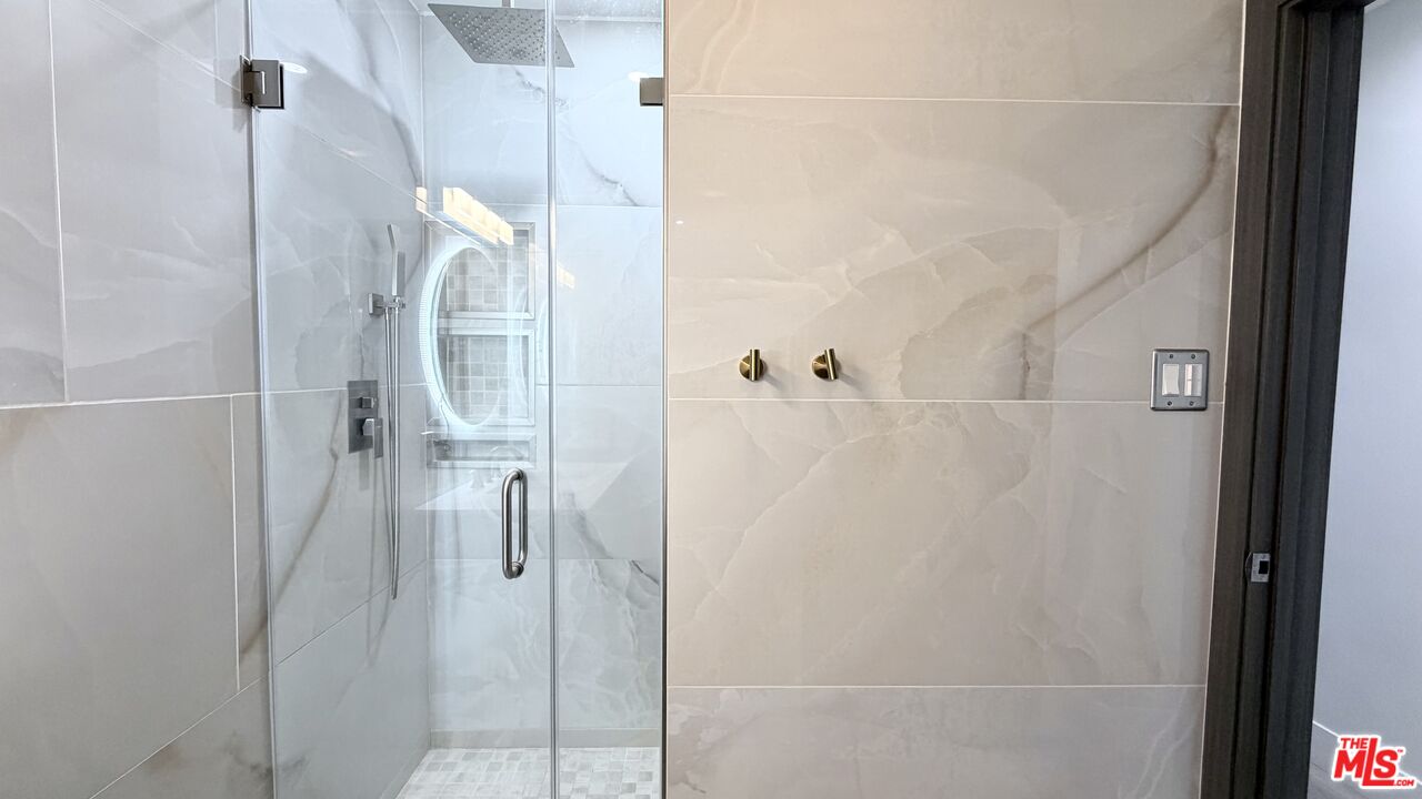 11836 Rialto Street Sun Valley, CA 91352 - Photo 16 of 34 a bathroom with a glass shower door