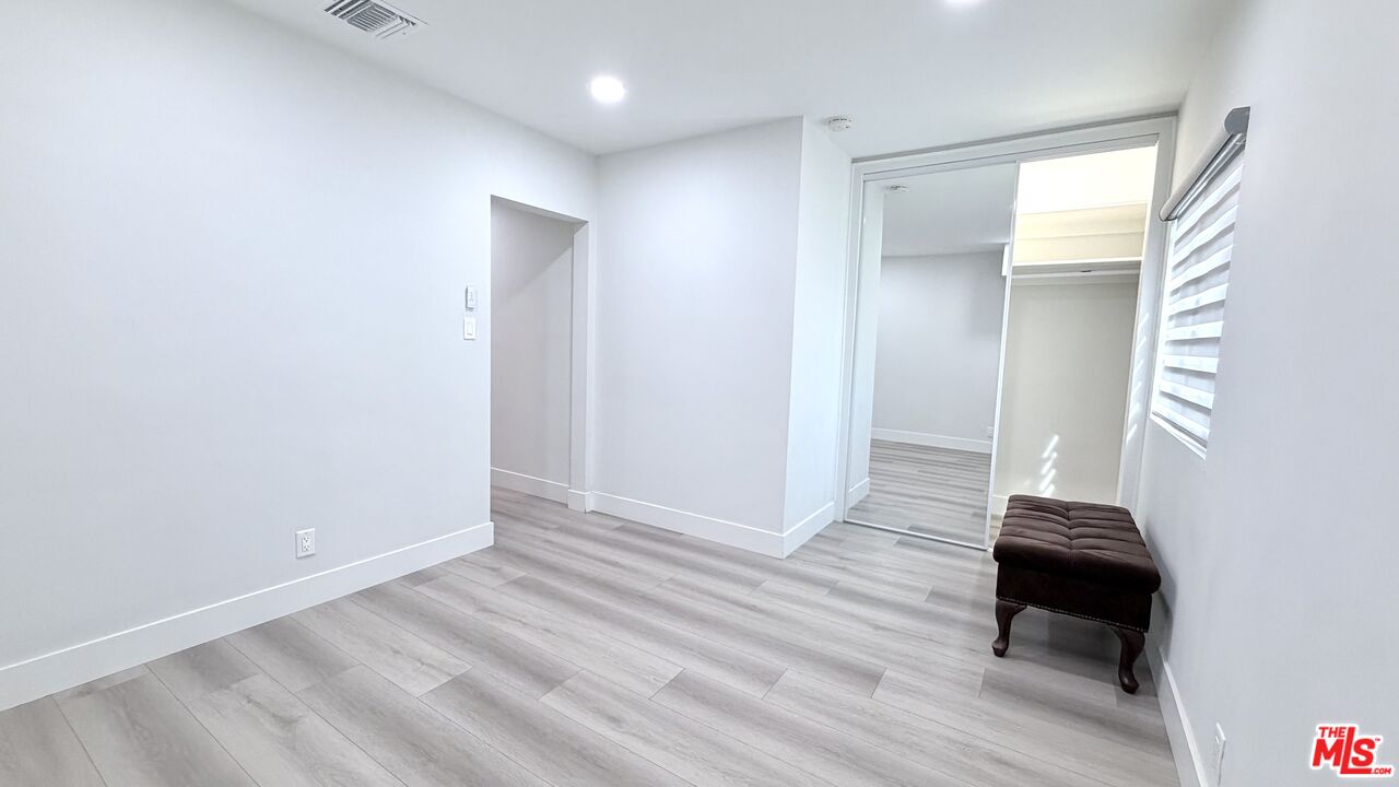 11836 Rialto Street Sun Valley, CA 91352 - Photo 19 of 34 a view of a hallway with wooden floor and cabinet