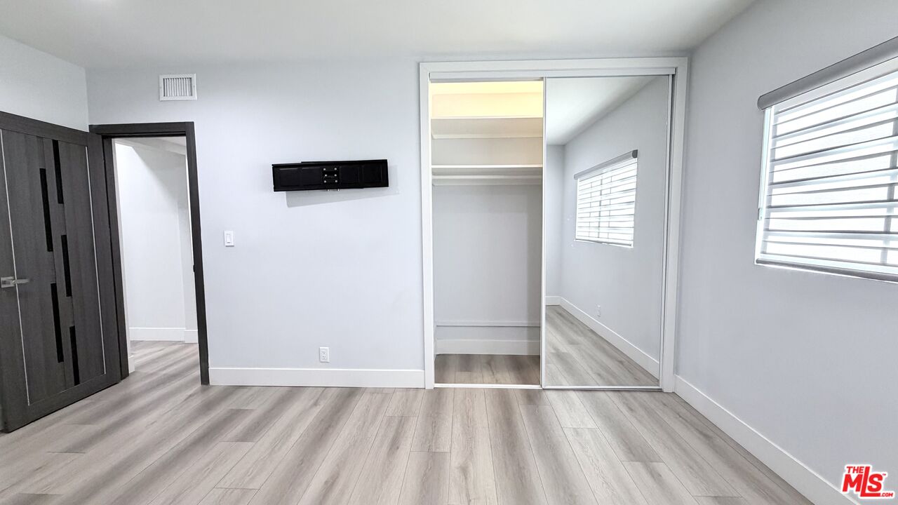 11836 Rialto Street Sun Valley, CA 91352 - Photo 21 of 34 a view of empty room with wooden floor and fan