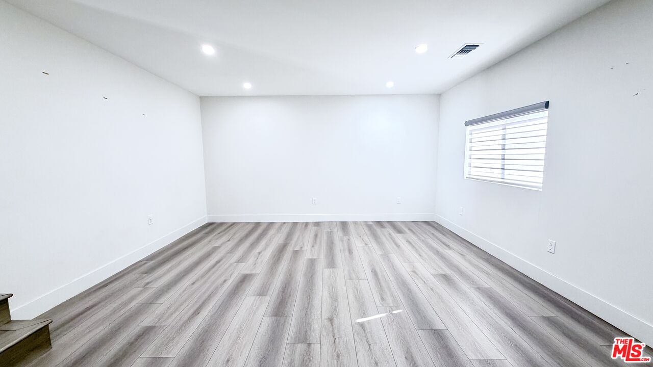 11836 Rialto Street Sun Valley, CA 91352 - Photo 5 of 34 a view of a room with wooden floor and window