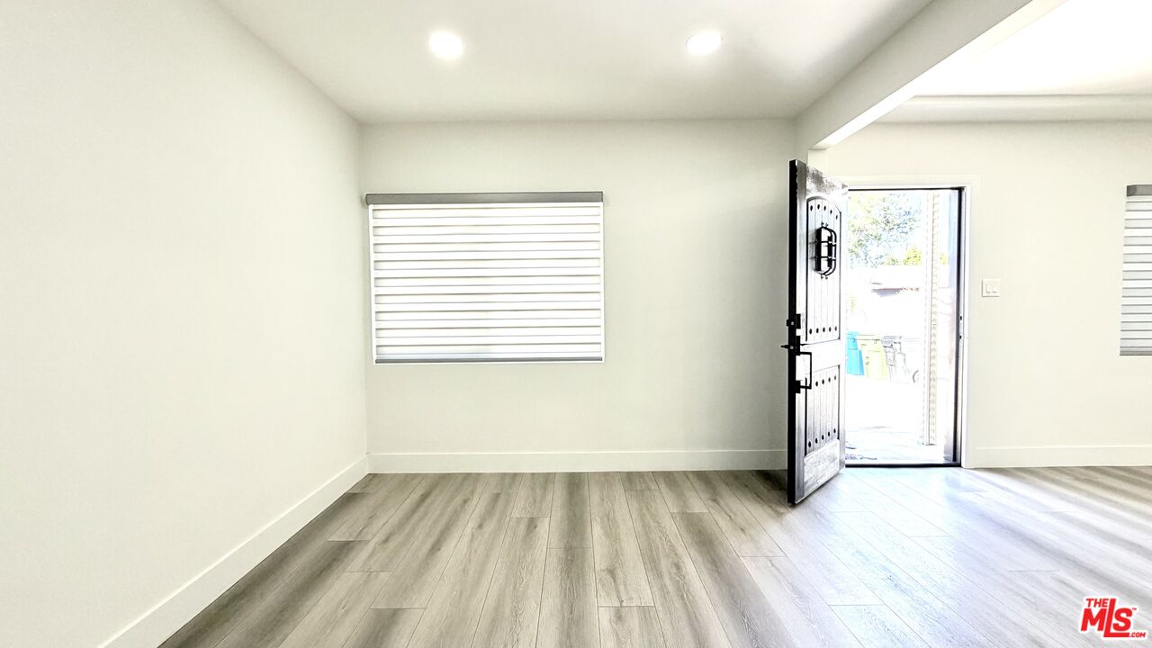 11836 Rialto Street Sun Valley, CA 91352 - Photo 7 of 34 an empty room with wooden floor and windows