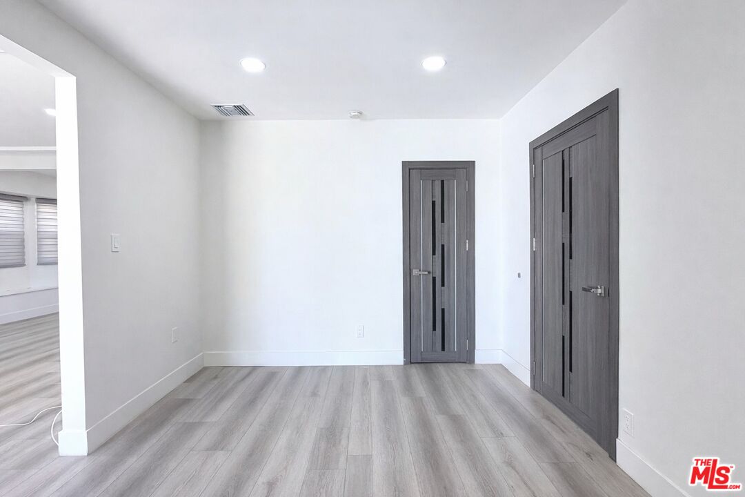 11836 Rialto Street Sun Valley, CA 91352 - Photo 10 of 34 an empty room with closet and wooden floor