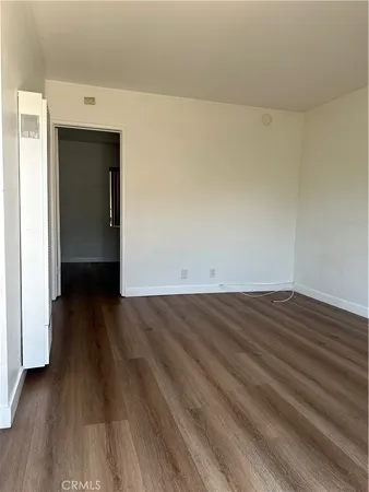 a view of a room with wooden floor and wooden floor