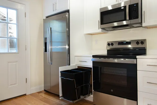 a kitchen with kitchen island granite countertop stainless steel appliances and a sink