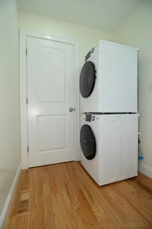 a view of a room with wooden floor and cabinets