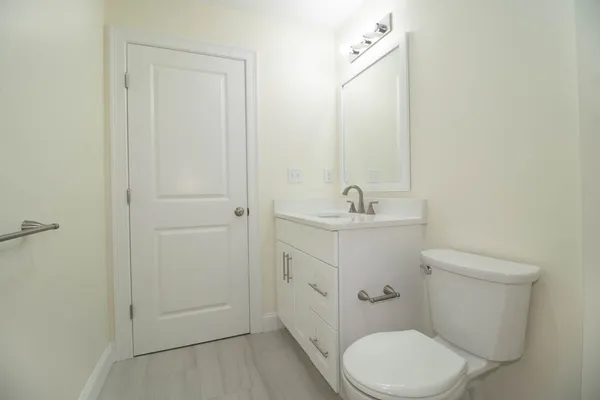 a bathroom with a sink a toilet and vanity