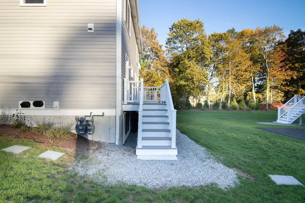 a view of a house with backyard and sitting area