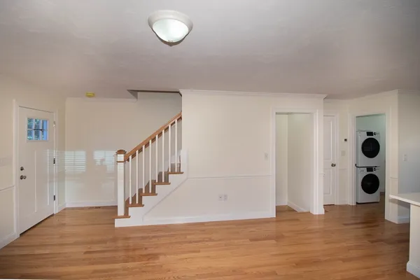 a view of an entryway with wooden floor