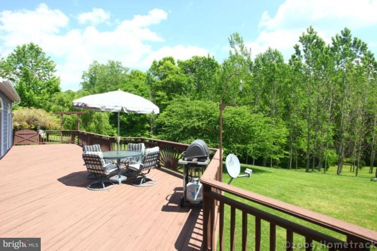 2637 Stockton Road Phoenix, MD 21131 - Photo 14 of 25 a view of a patio with a table chairs and a umbrella