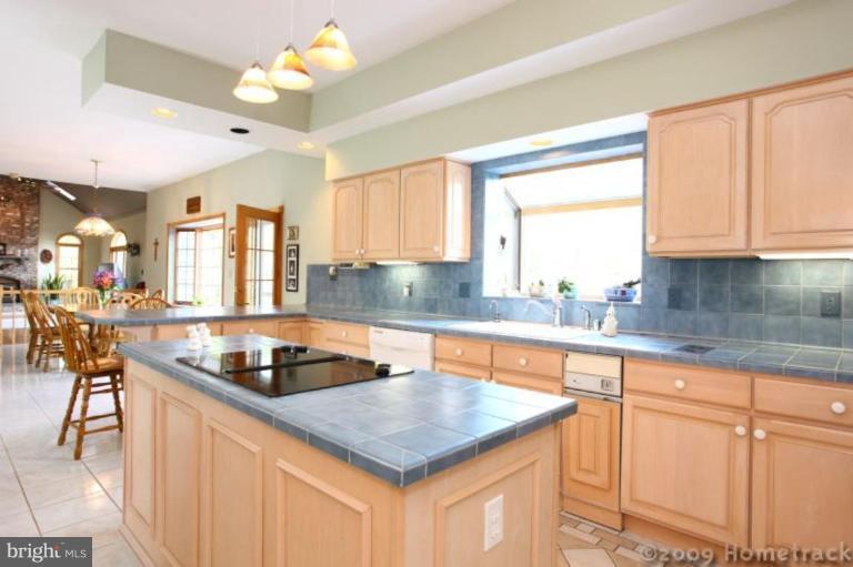 2637 Stockton Road Phoenix, MD 21131 - Photo 5 of 25 a kitchen with granite countertop a sink a counter top space and living room area