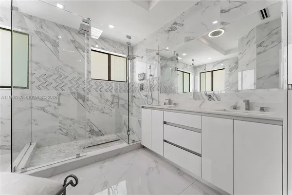 a white toilet sitting next to a bathroom sink