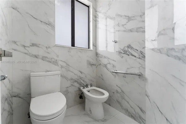 a bedroom with bed and a window