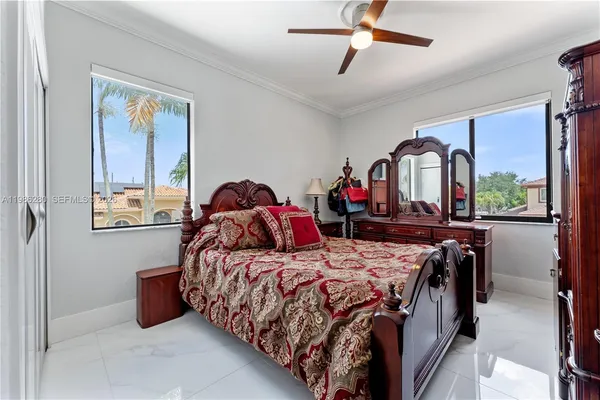 a bedroom with a bed and a flat tv screen on dresser