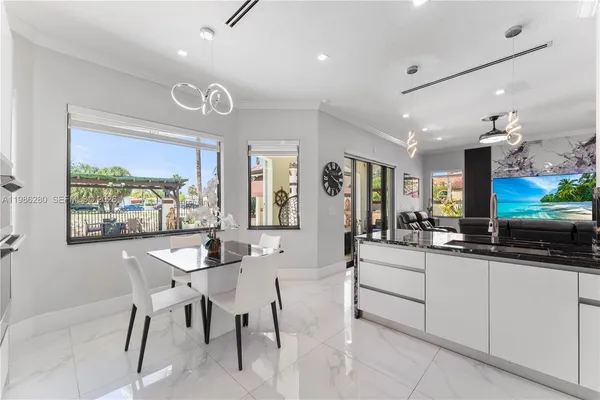 a living room with furniture a flat screen tv and a large window