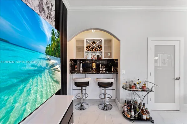 a view of a patio with table and chairs potted plants and palm tree
