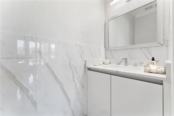 a view of a patio with table and chairs under an umbrella