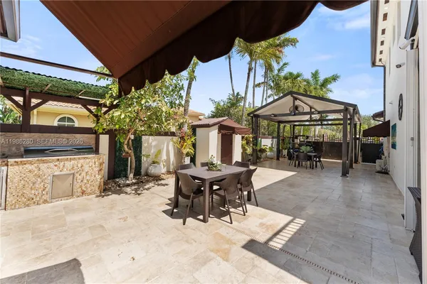 a view of a house with a swimming pool and sitting area