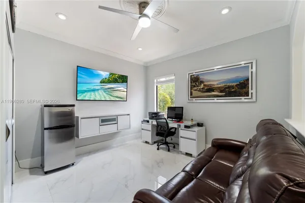 a bedroom with furniture and a flat screen tv