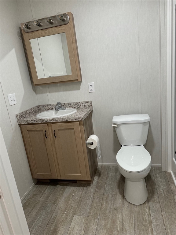 200 North Street Danvers, MA 01923 - Photo 8 of 16 a bathroom with a toilet a sink and mirror