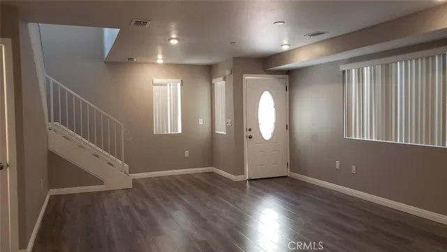 a view of entryway with stairs and wooden floor