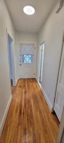 wooden floor in a hall with an empty room