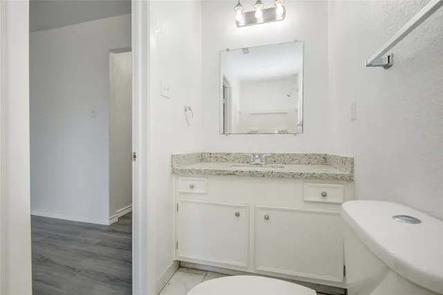 a bathroom with a sink toilet vanity and tub