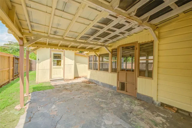 a view of a porch with wooden fence