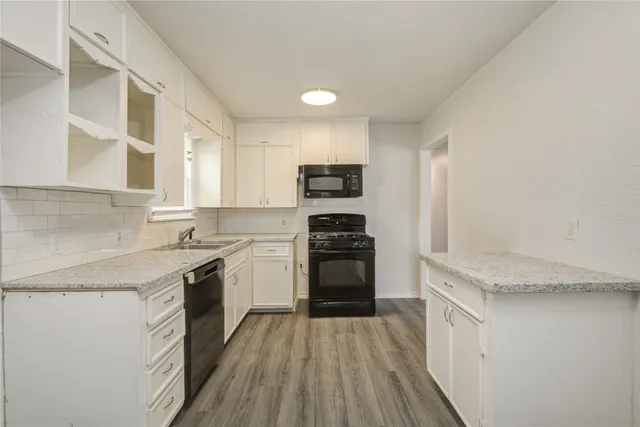 a kitchen with granite countertop stainless steel appliances and wooden cabinets