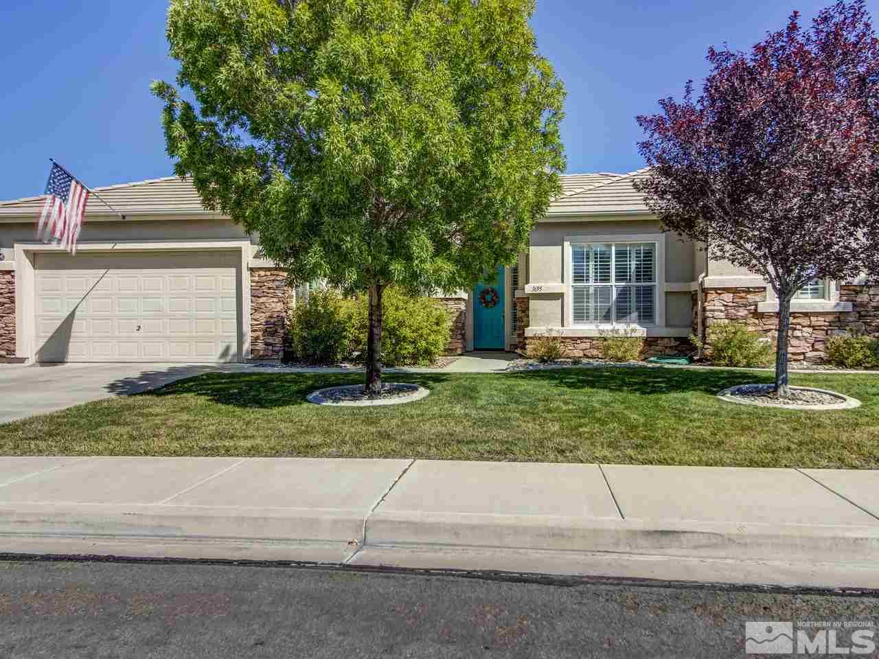 1695 Crater Court Reno, NV 89521 - Photo 1 of 25 a front view of a house with a yard and an trees