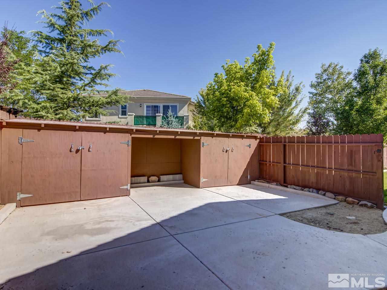 1695 Crater Court Reno, NV 89521 - Photo 23 of 25 a backyard of a house with lawn chairs and wooden fence