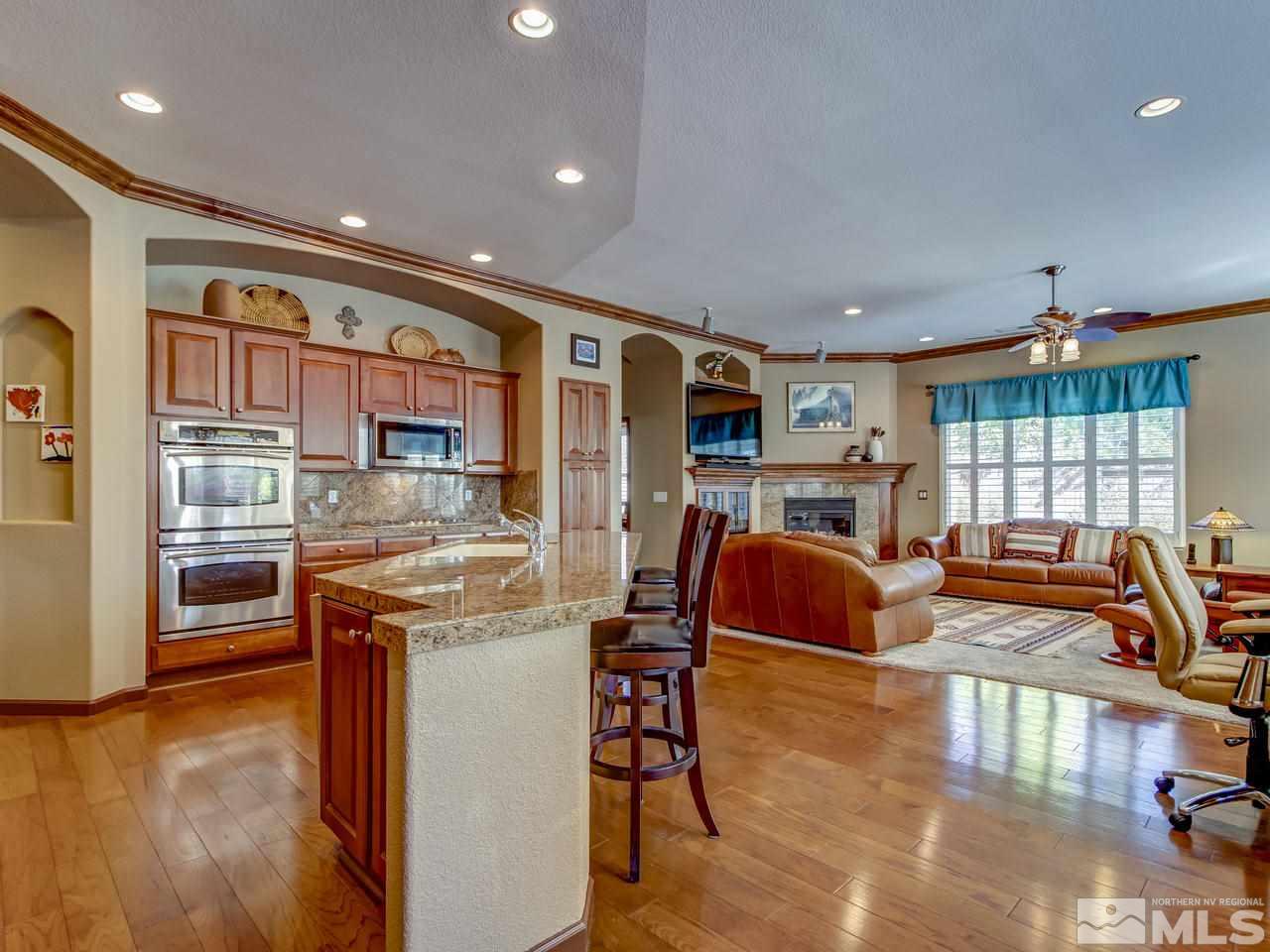 1695 Crater Court Reno, NV 89521 - Photo 8 of 25 a living room with fireplace furniture and a wooden floor