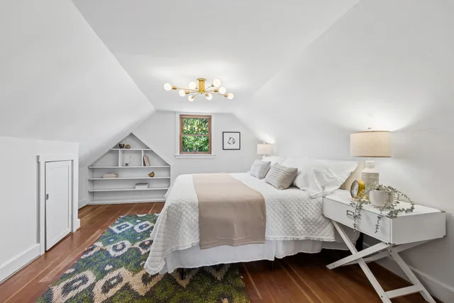 a bedroom with a bed table and window