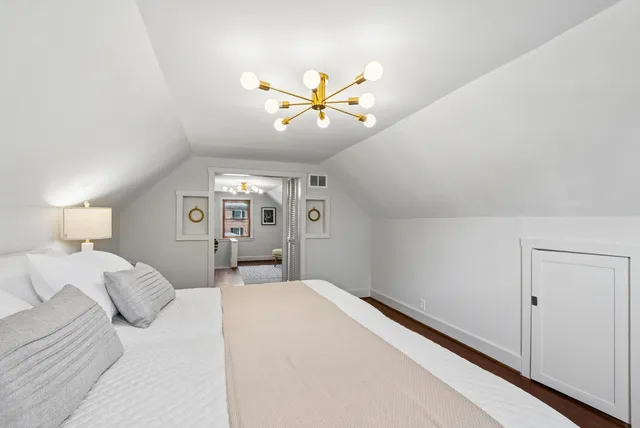 a bedroom with a bed and a ceiling fan