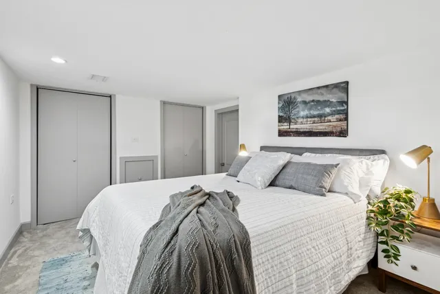 a bed room with a bed and a painting