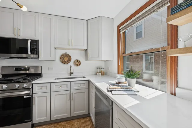 a kitchen with a sink stove top oven and cabinets