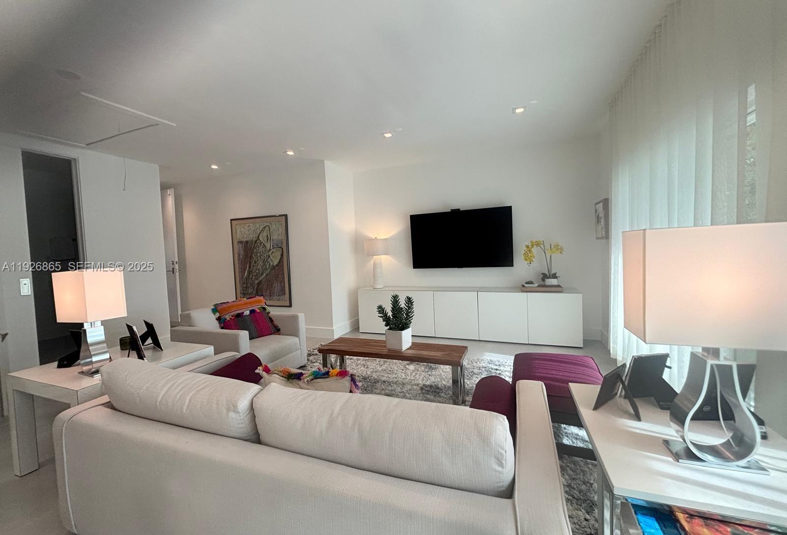 9121 Southwest 85th Street, Unit 2 Miami, FL 33173 - Photo 13 of 26 a living room with furniture and a flat screen tv