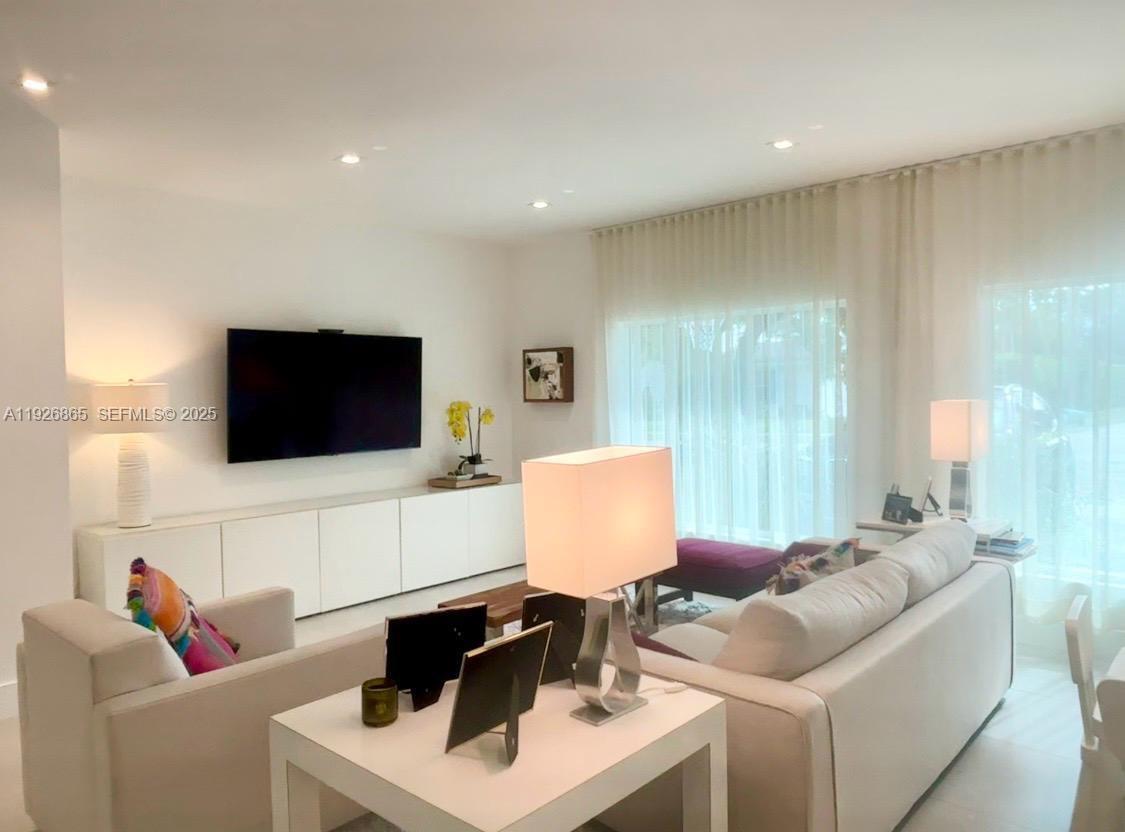 9121 Southwest 85th Street, Unit 2 Miami, FL 33173 - Photo 14 of 26 a living room with furniture and a flat screen tv