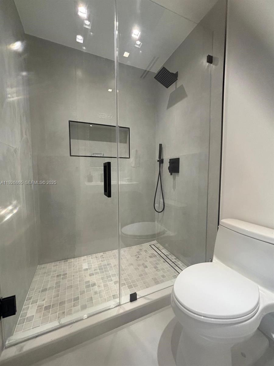 9121 Southwest 85th Street, Unit 2 Miami, FL 33173 - Photo 15 of 26 a bathroom with a toilet and a shower