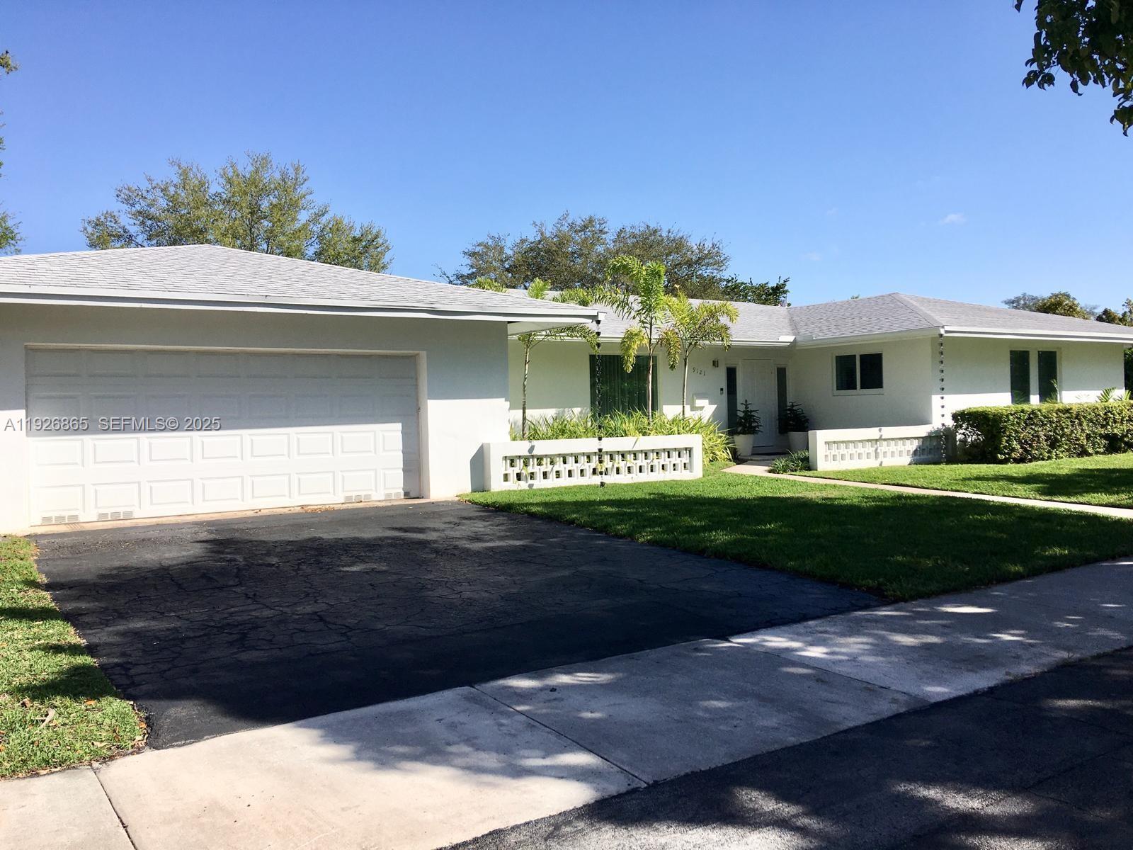 9121 Southwest 85th Street, Unit 2 Miami, FL 33173 - Photo 16 of 26 a front view of a house with a garden