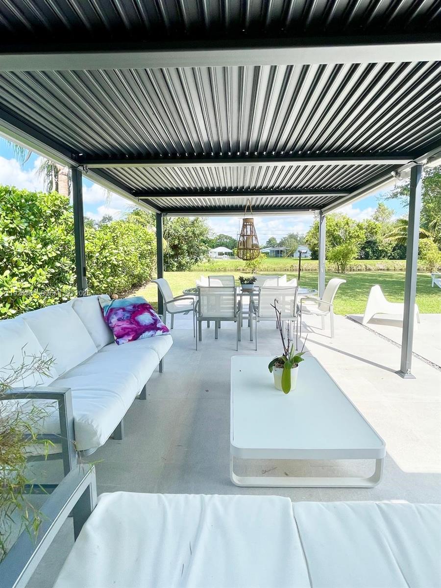 9121 Southwest 85th Street, Unit 2 Miami, FL 33173 - Photo 18 of 26 a view of a patio with a table and chairs