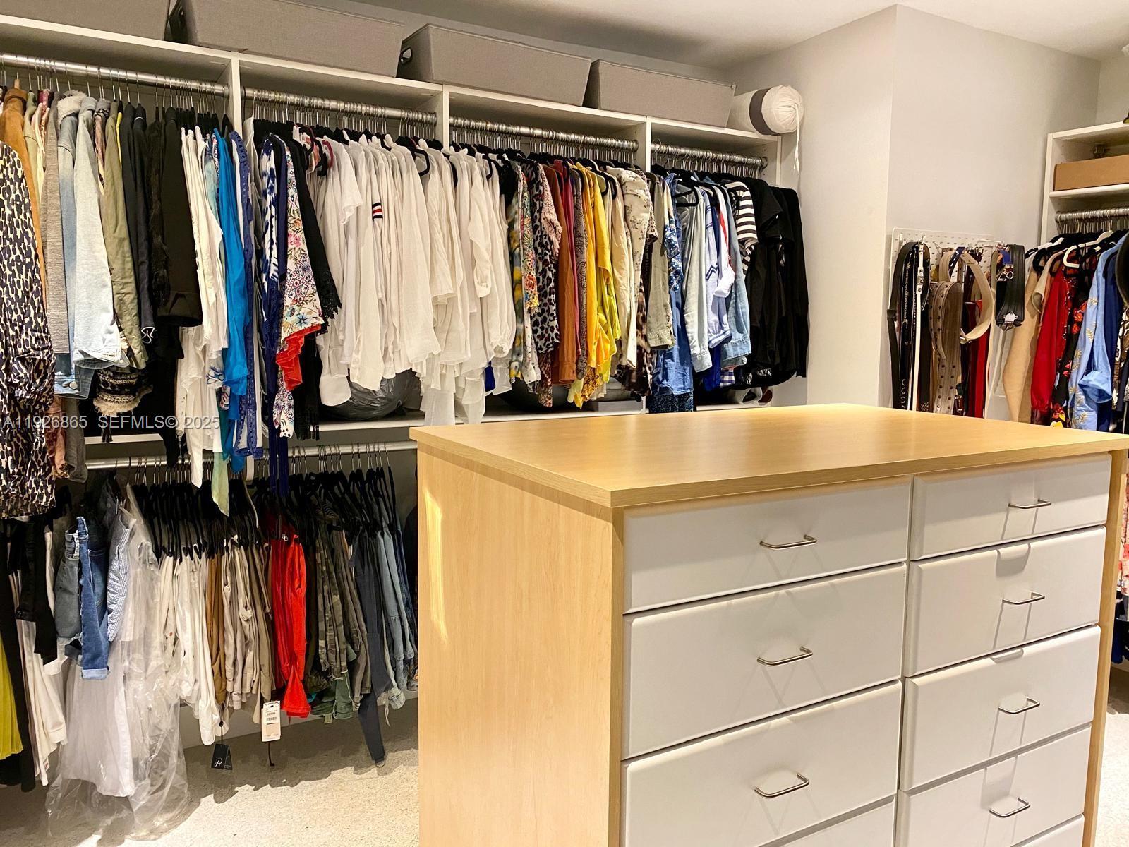 9121 Southwest 85th Street, Unit 2 Miami, FL 33173 - Photo 22 of 26 a view of walk in closet with clothes and shoes