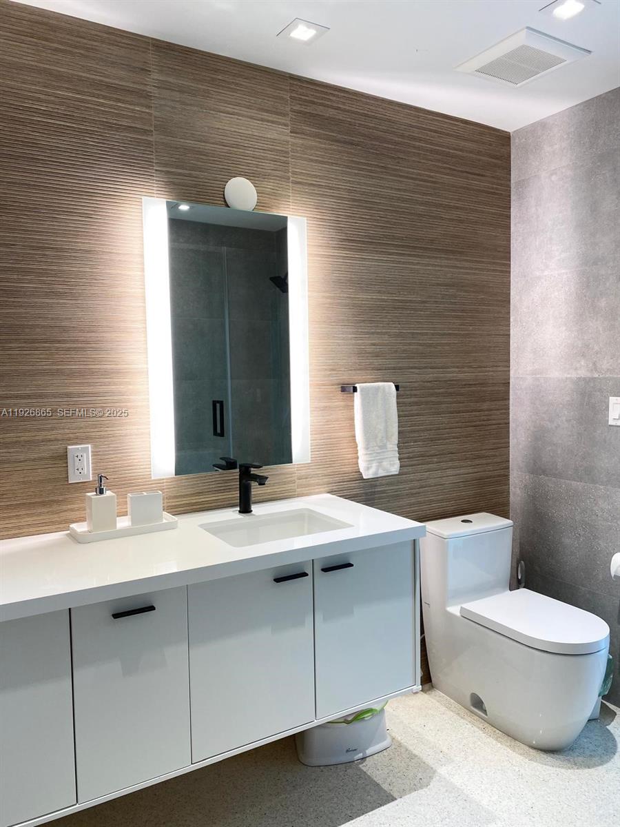 9121 Southwest 85th Street, Unit 2 Miami, FL 33173 - Photo 24 of 26 a bathroom with a sink toilet and mirror