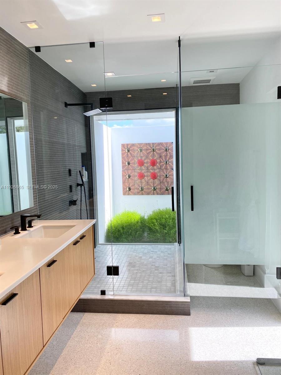 9121 Southwest 85th Street, Unit 2 Miami, FL 33173 - Photo 25 of 26 a bathroom with a tub a sink and mirror