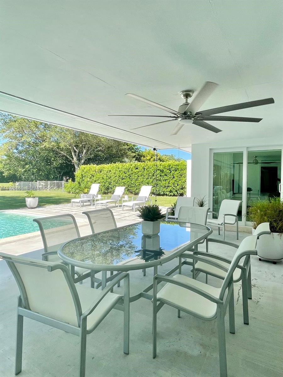 9121 Southwest 85th Street, Unit 2 Miami, FL 33173 - Photo 5 of 26 a dining room with furniture and a large window
