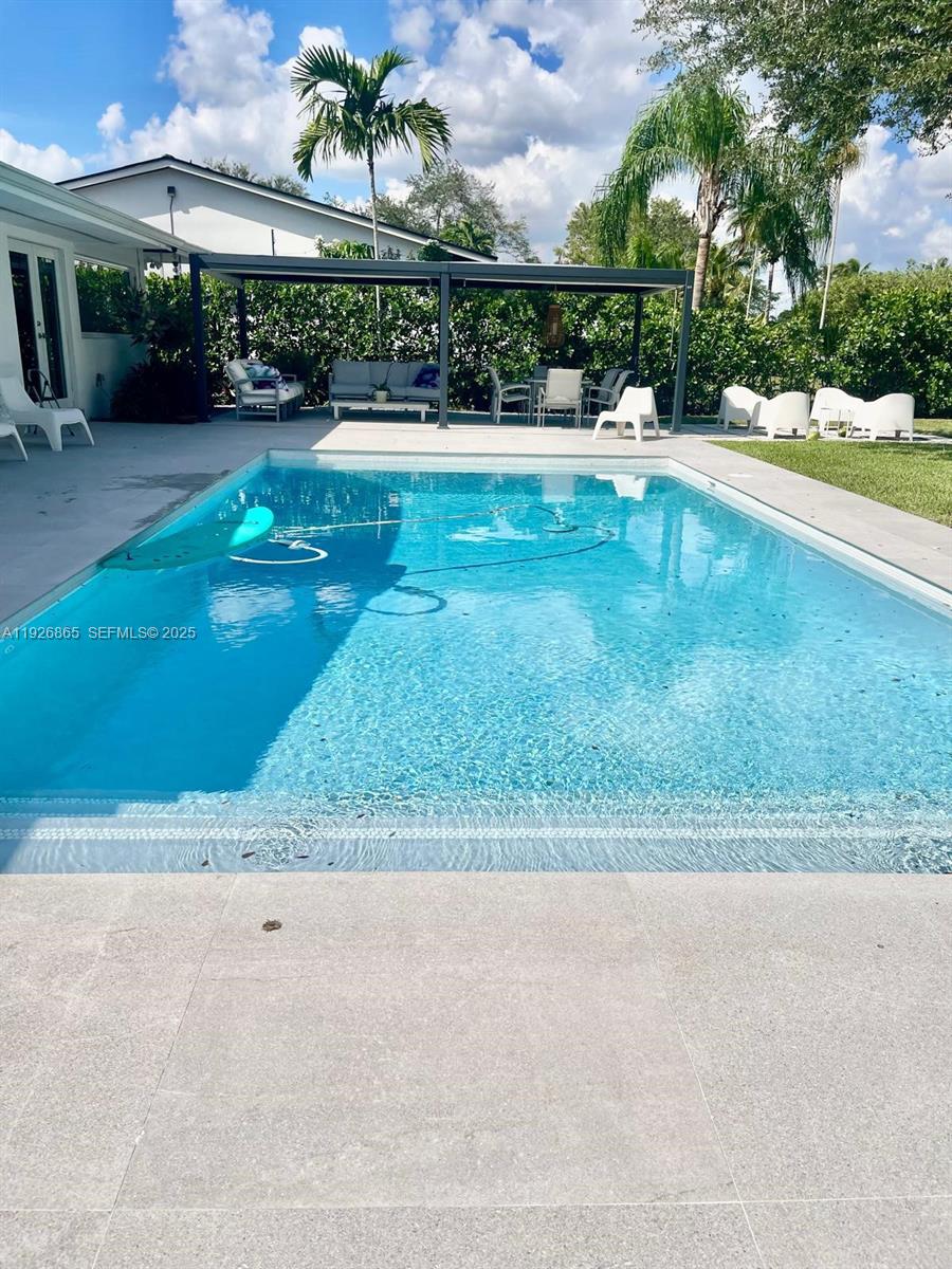 9121 Southwest 85th Street, Unit 2 Miami, FL 33173 - Photo 9 of 26 a view of a swimming pool and a yard